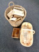 A wicker log basket containing logs together with two wooden baskets