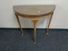 A Demi Lune hall table on pad feet