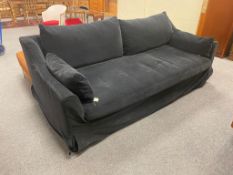 An Ikea black three seater bed settee