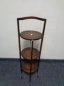 A three tier mahogany cake stand