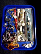 A tray of a collection of costume jewellery to include beaded necklaces, brooches, simulated pearls,