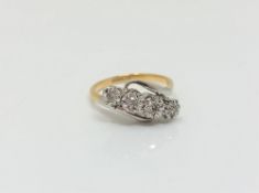 An 18ct gold and platinum four stone diamond ring,