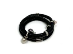 A Story Bangle by Kranz & Ziegler with six silver charms including a black pearl