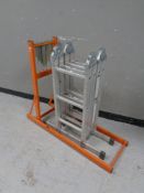 A folding aluminium multi purpose ladder together with a log horse