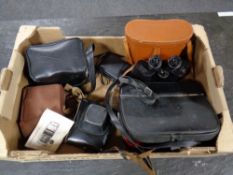 A box of cased Regent 10x50 field glasses, vintage cameras,