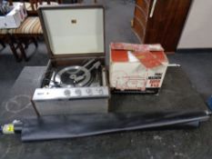 A HMV tabletop record player together with a boxed Prinz projector and a projector screen