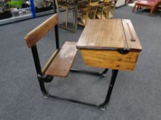 A mid 20th century child's school desk with seat
