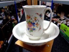 An antique floral transfer printed wash jug and basin
