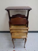 A nest of three beech glass and leather top tables together with a magazine rack in a mahogany