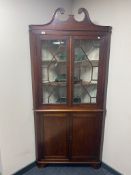 A 19th century double door mahogany corner cabinet fitted cupboards beneath