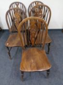 A set of five stained beech wheel back chairs