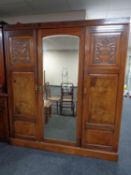 A late Victorian burr walnut compactum triple wardrobe