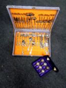 A canteen of stainless steel cutlery together with a set of six plated miniature goblets