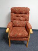 A contemporary armchair in buttoned upholstery