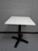 Sixteen square topped cafe tables on pedestals