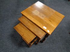 A nest of three oak tables