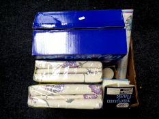 A box containing new bedding, desk fan,