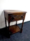 An oak side table fitted a drawer