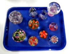 A tray containing 10 assorted glass paperweights