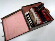 A case containing Hohner Erica accordion together with a further Hohner mouth organ