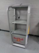 A shop display fridge bearing Red Bull advertising