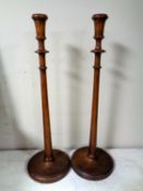 A pair of Edwardian mahogany candlesticks, height 53.