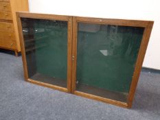 A 20th century oak double door wall notice cabinet
