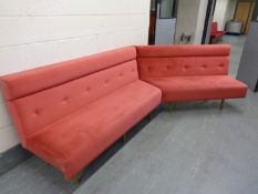 A twin section function room V-shaped bench seat upholstered in pink button dralon