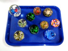 A tray containing 10 assorted glass paperweights