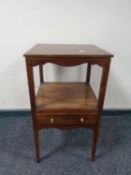 An inlaid mahogany two tier bedside stand fitted a drawer