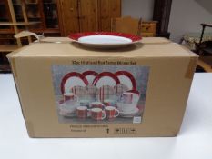 A boxed Waterside 32 piece Highland red tartan dinner set