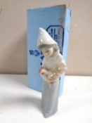 A Lladro figure of a girl holding a cockerel,
