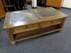 A contemporary beech and wicker glass topped two tier coffee table