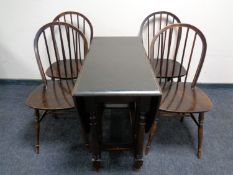 A stained beech drop leaf dining table and a set of four spindle back chairs