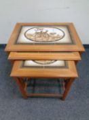 A nest of three 20th century Mobel Fabrikken Danish teak tiled topped tables