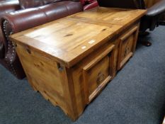A contemporary pine storage coffee table