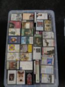 A large plastic storage crate with lid containing a large quantity of VHS and cassette tapes to