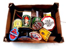 A box of a quantity of beer pump badges and drip mats