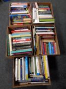 Five boxes containing a large quantity of hardback and paperback books to include cookery,