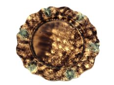 An 18th century Whieldon pottery plate. CONDITION REPORT: Stapled.