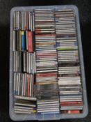 A large plastic storage crate containing a large quantity of CDs,