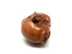 A carved hardwood netsuke - Two rats on a pot