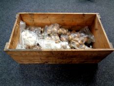A vintage pine crate containing assorted wooden handles
