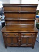 An Ercol solid elm and beech Welsh dresser in an antique finish