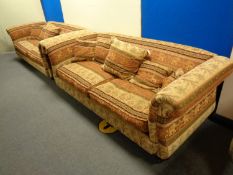 A pair of contemporary oversized scroll arm settees upholstered in an Indian style fabric
