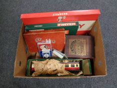 A box containing vintage and later games, a large scale tin plate train carriage, stamp album,