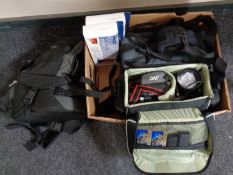 A box of video cameras in bags, camera bags,