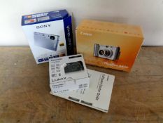 Three boxed digital cameras to include Canon Powershot A630,