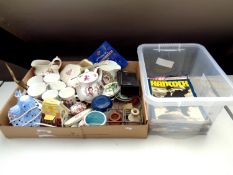 A box of assorted china to include commemorative ware, dressing table brushes, harmonica with book,