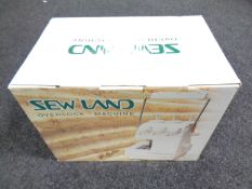 A boxed Sew Land over locking sewing machine
